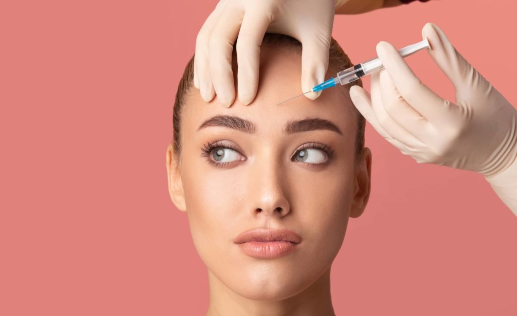 young-woman-receiving-botox-beauty-injection-in-forehead